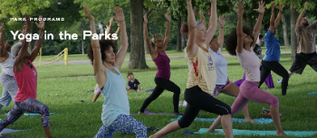 people outside doing yoga poses